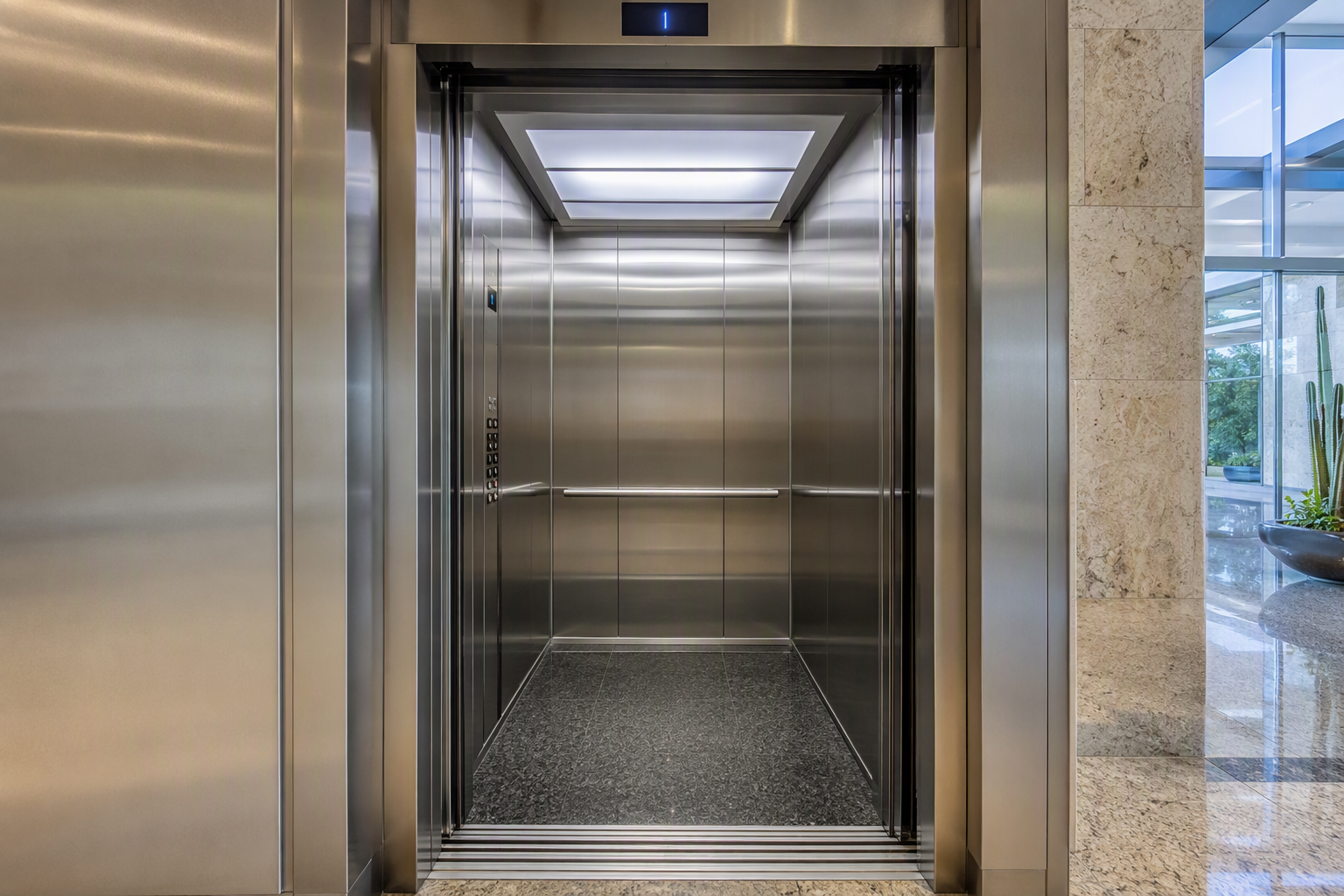 Modernized elevator cab interior with new stainless steel finishes, LED lighting, and updated fixtures representing a capital improvement upgrade in an Arizona commercial building
