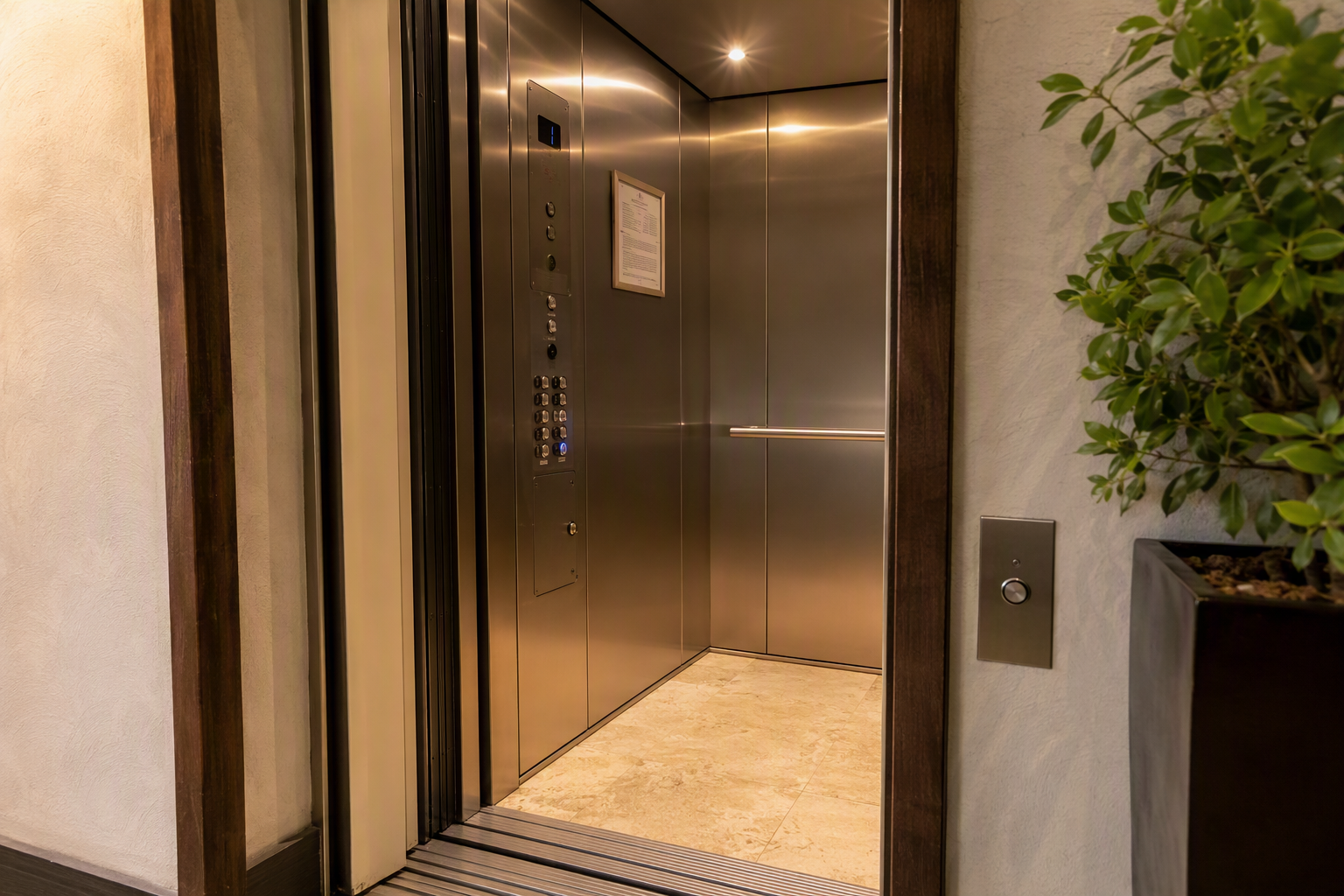 Newly modernized elevator cab interior with ADA-compliant controls, brushed stainless steel panels, and LED lighting in a Scottsdale Arizona commercial building