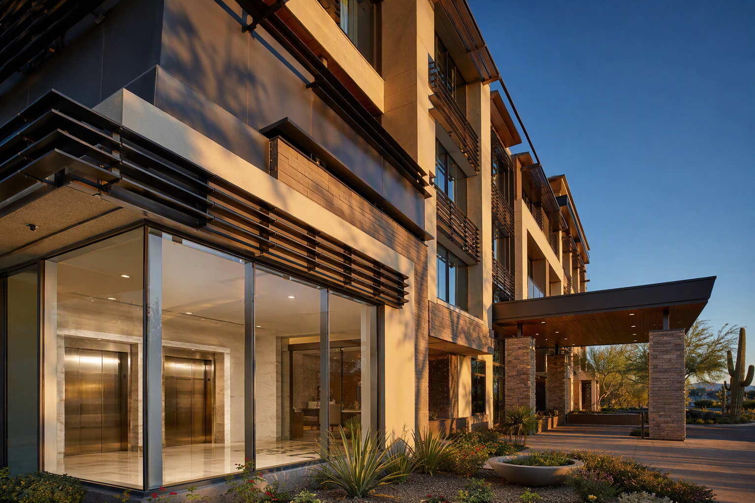 Modern mid-rise hotel building in Scottsdale Arizona with elevator lobby visible through ground-floor windows, illustrating elevator requirements for new multifamily and hotel construction