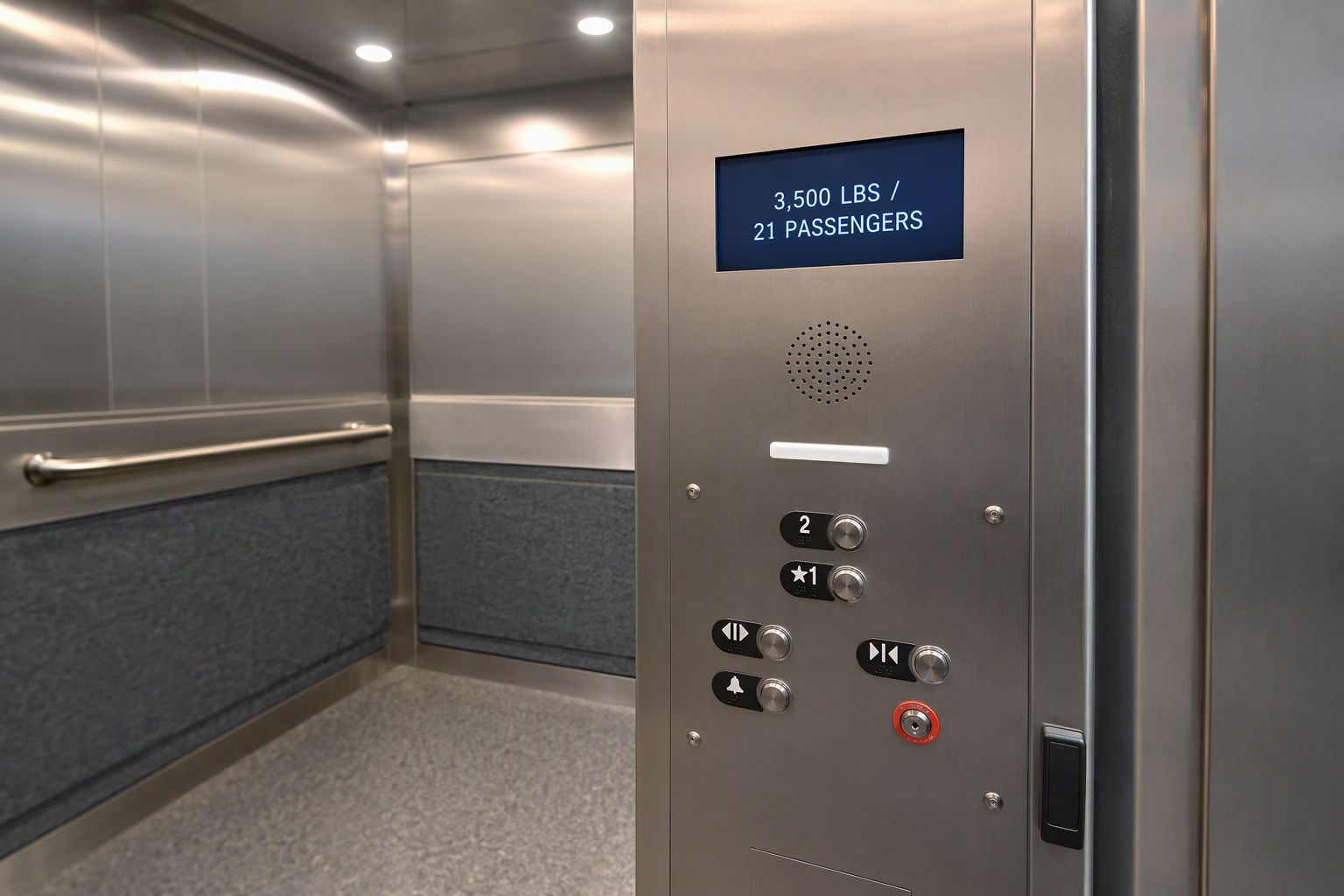 Interior of a wide-platform commercial elevator cab in a Scottsdale Arizona medical building showing capacity-rated stainless steel finishes and LED control panel.